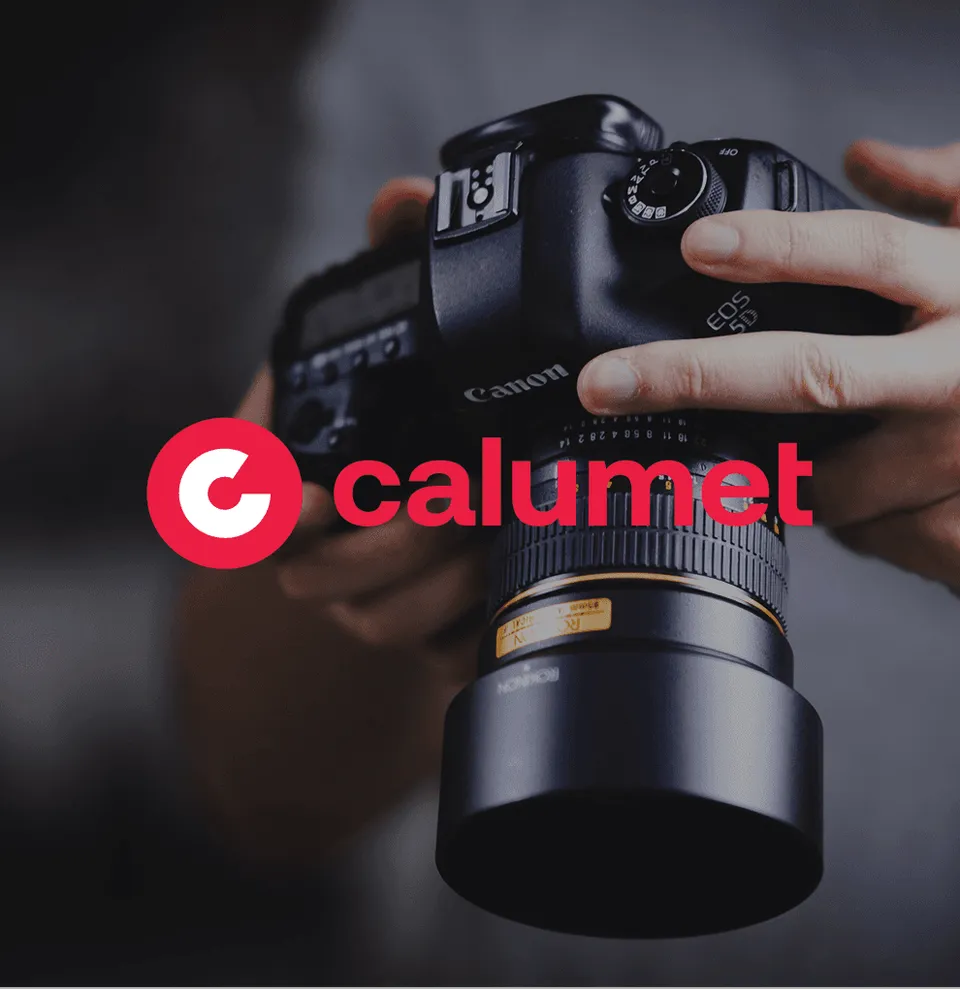 A photographer holding a DSLR camera, with the Calumet logo above